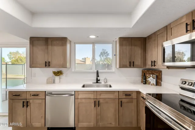 a kitchen with a sink cabinets and window
