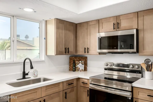 a kitchen with a sink and appliances