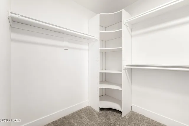 a view of walk in closet with empty racks