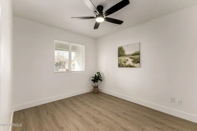 wooden floor in an empty room with a window