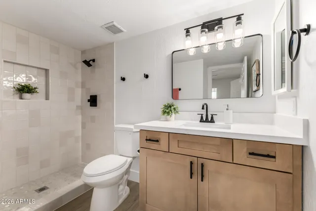 an empty room with a window and a ceiling fan