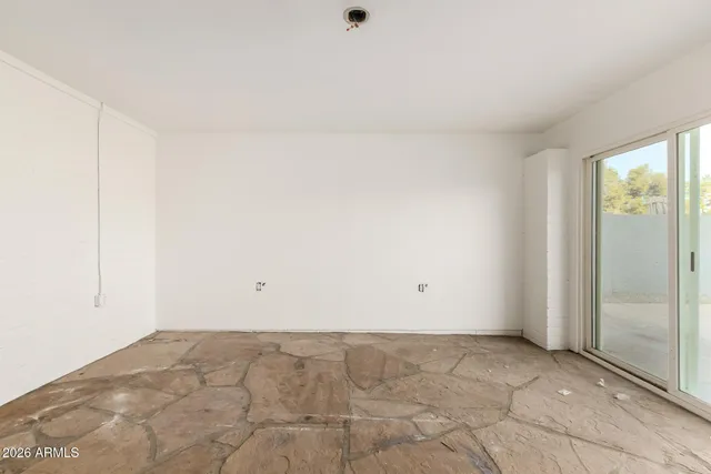 a view of an empty room with a window