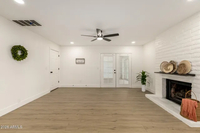 a view of an empty room with a fireplace