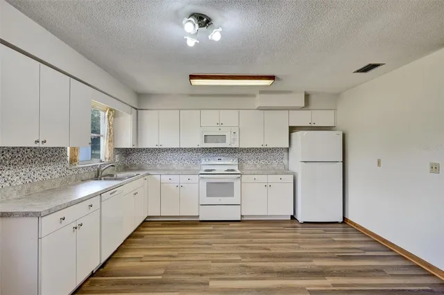 a kitchen with a sink and cabinets