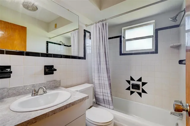 a bathroom with a sink toilet and a mirror