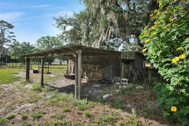a backyard of a house with table and chairs