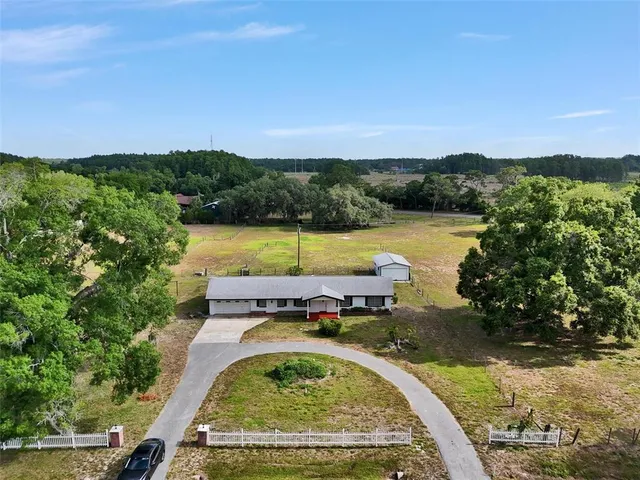 a view of a swimming pool with a yard and lake view
