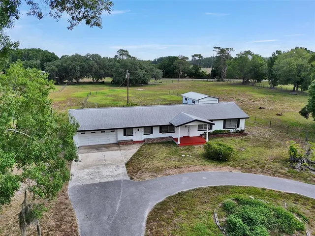 an aerial view of a house with big yard