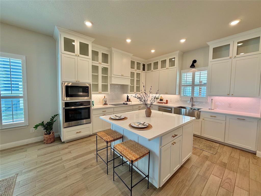 649 Gray Road Burleson, TX 76028 - Photo 13 of 28 a large white kitchen with a sink and dishwasher a stove with wooden floor