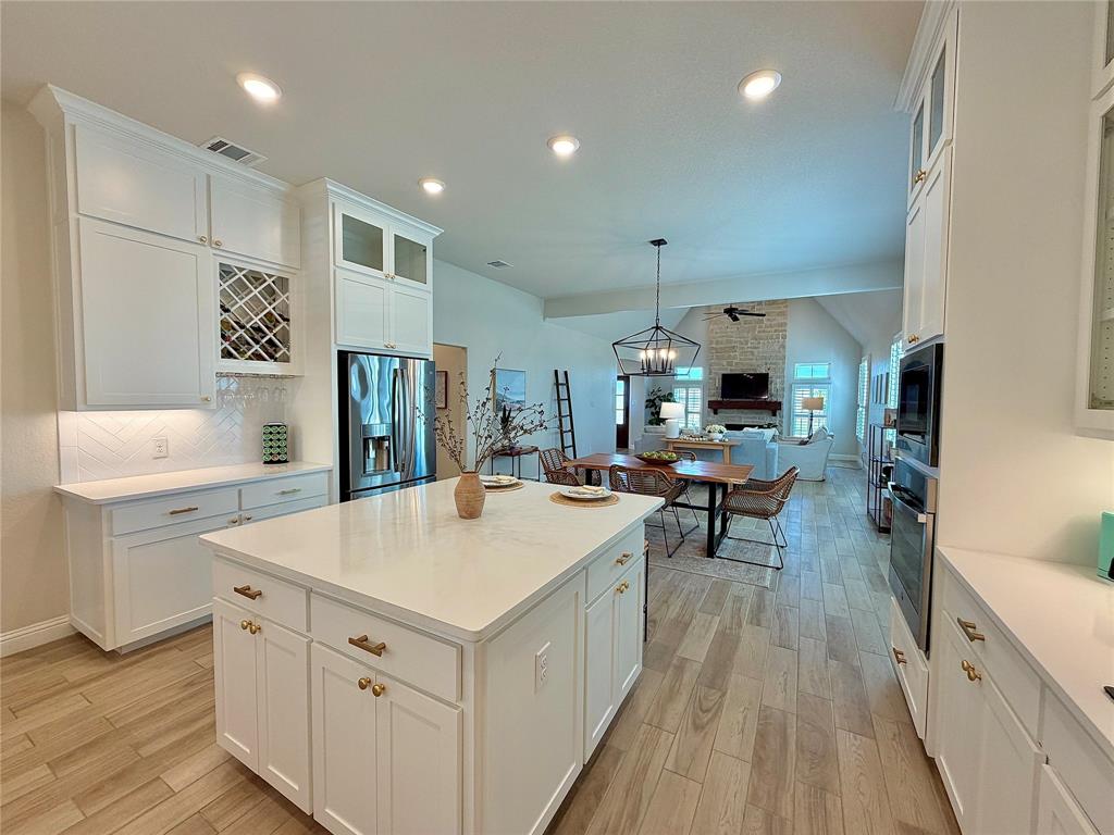 649 Gray Road Burleson, TX 76028 - Photo 14 of 28 a kitchen with a sink a counter top space stainless steel appliances and wooden floor