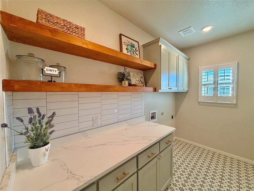 649 Gray Road Burleson, TX 76028 - Photo 17 of 28 a bath room with a sink and cabinets