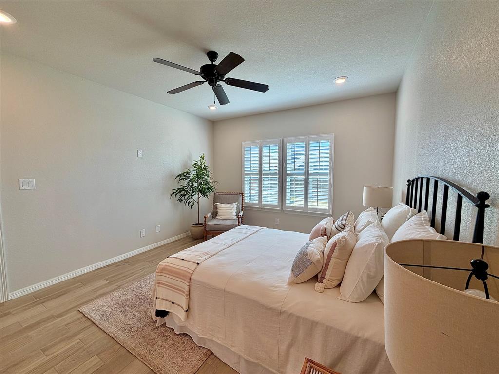 649 Gray Road Burleson, TX 76028 - Photo 21 of 28 a bedroom with a bed and a chandelier