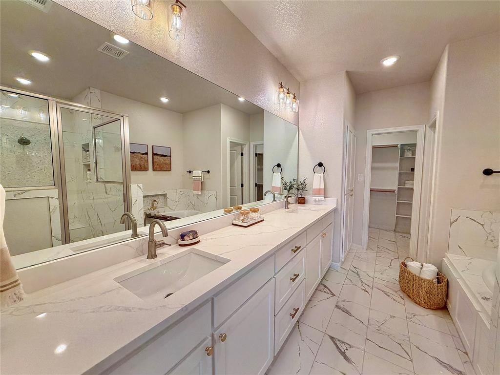 649 Gray Road Burleson, TX 76028 - Photo 23 of 28 a spacious bathroom with a double vanity sink mirror and shower