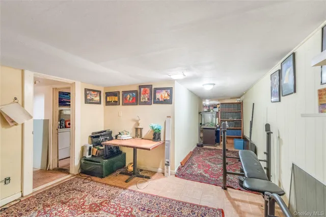 a living room with furniture a rug and a bookshelf