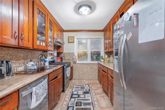 a kitchen with stainless steel appliances granite countertop a sink and cabinets