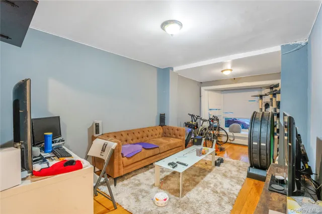 a room with gym equipment and a flat screen tv