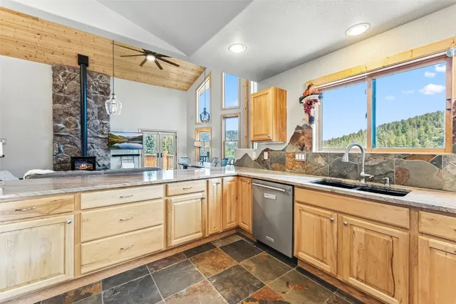 a large kitchen with a large window and cabinets
