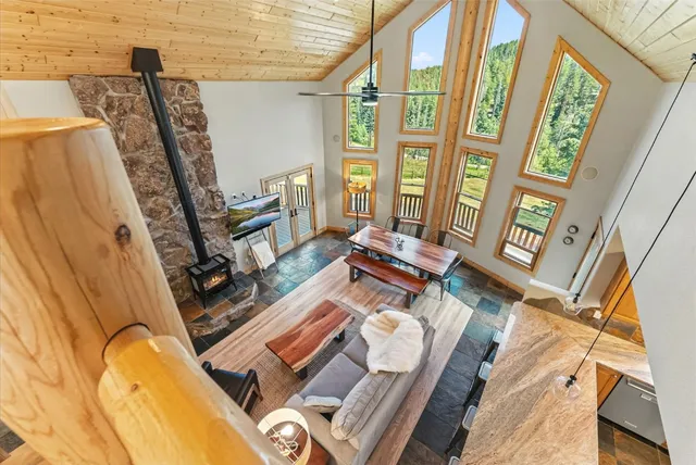 a living room with furniture and a floor to ceiling window