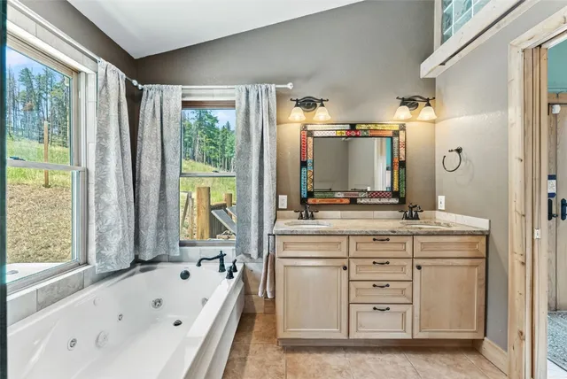 a bathroom with a tub sink and mirror