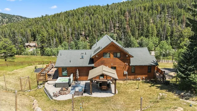 an aerial view of a house with swimming pool and garden