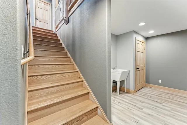 a view of an entryway with wooden floor and stairs