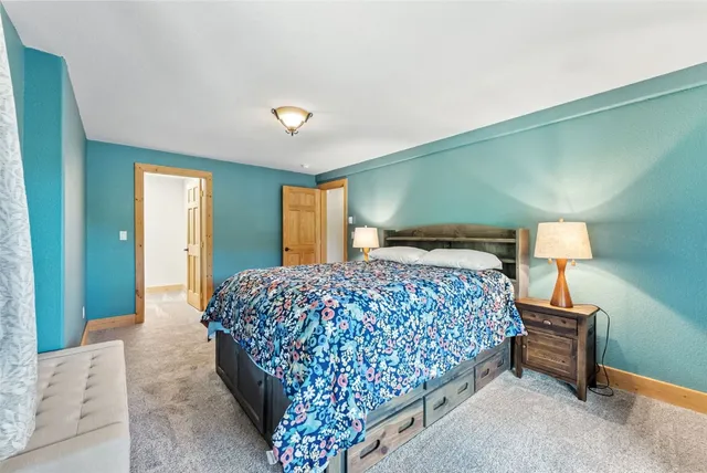 a bedroom with a bed and a lamp