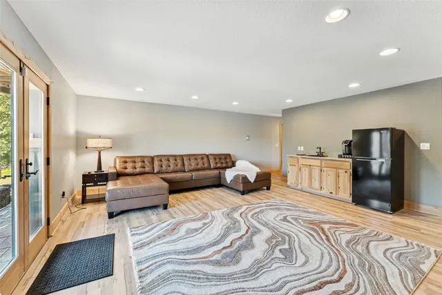 a large bedroom with a bed and a view of kitchen