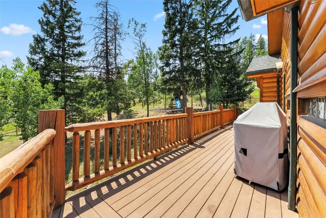 a view of a patio with table and chairs with wooden floor and fence