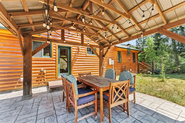 a view of a house with backyard porch and sitting area