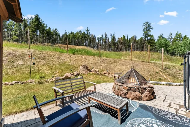 a view of a swimming pool with a patio and a yard