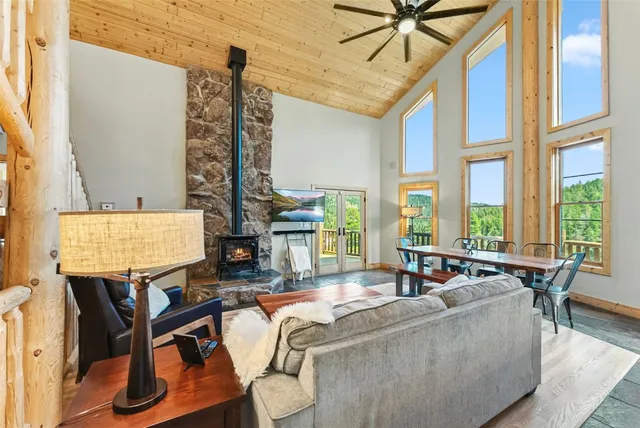 a living room with furniture and floor to ceiling windows