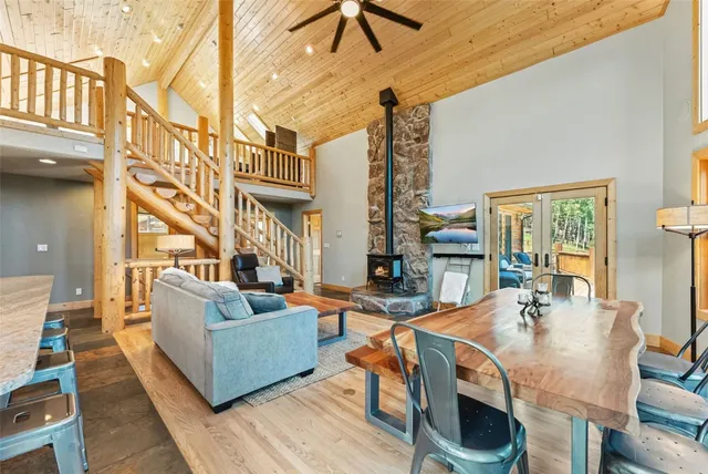 a living room with fireplace furniture and a large window