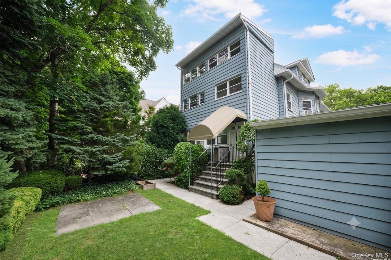 91 Parkway Road, Unit G1 Bronxville, NY 10708 - Photo 2 of 28 a front view of a house with garden