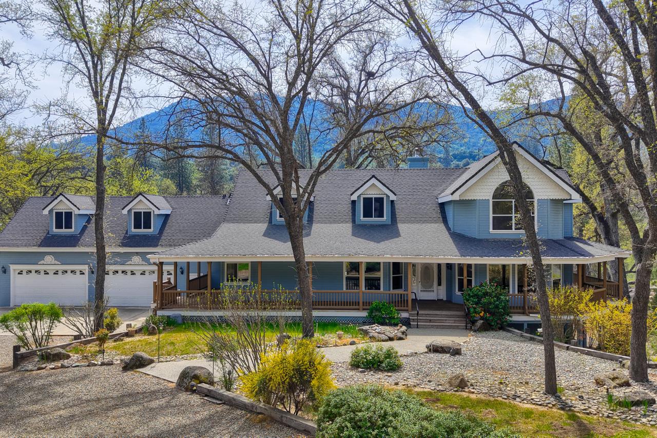 a front view of a house with swimming pool and sitting area