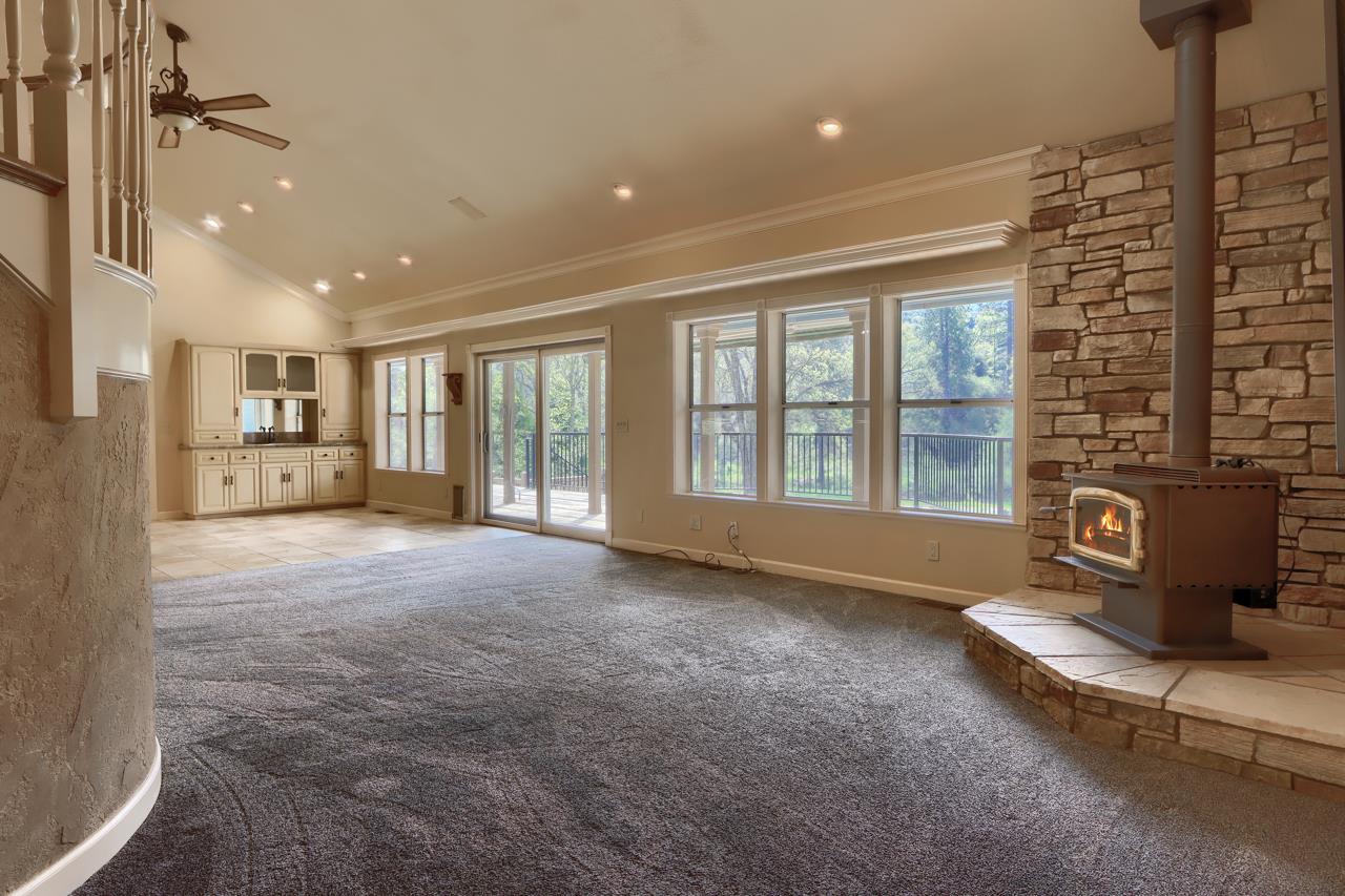 46580 Vista Del Rio Drive Oakhurst, CA 93644 - Photo 12 of 82 a view of an empty room with a fireplace and a window