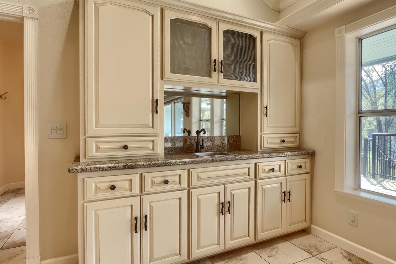 46580 Vista Del Rio Drive Oakhurst, CA 93644 - Photo 14 of 82 a bathroom with a granite countertop sink and a mirror