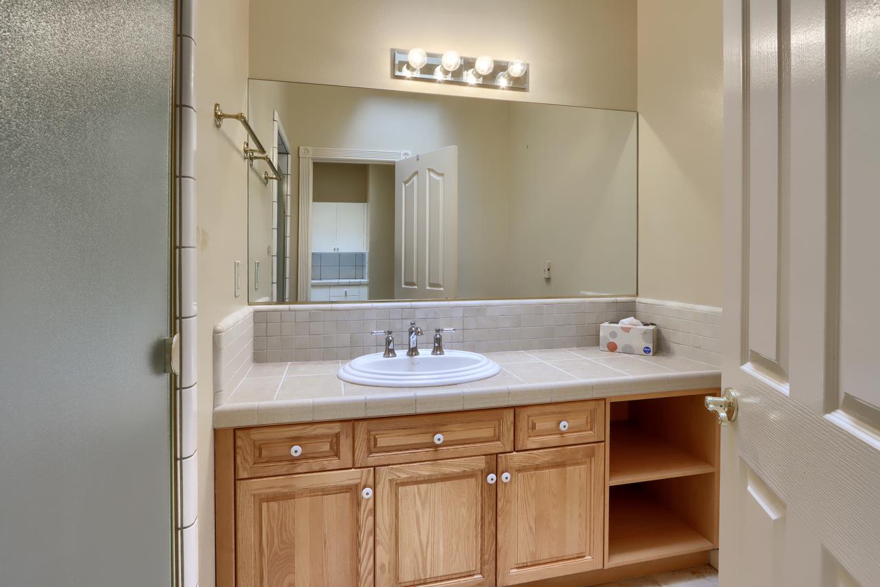 46580 Vista Del Rio Drive Oakhurst, CA 93644 - Photo 26 of 82 a bathroom with a sink and a mirror