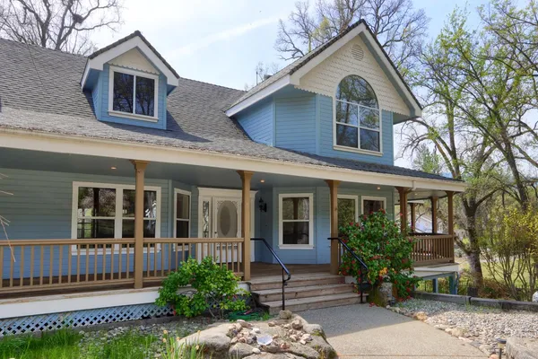 a front view of a house with a garden