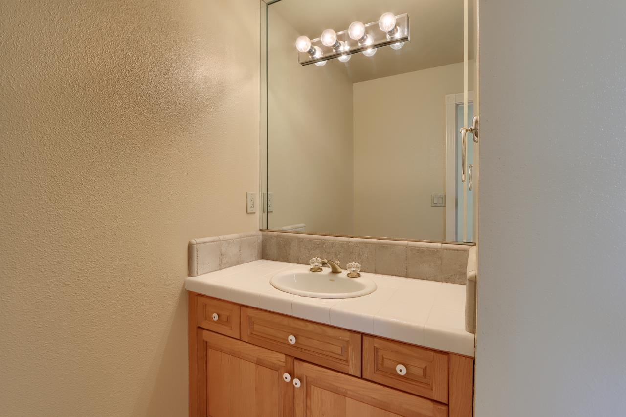 46580 Vista Del Rio Drive Oakhurst, CA 93644 - Photo 45 of 82 a bathroom with a sink vanity and a mirror