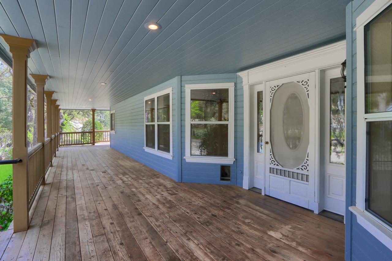46580 Vista Del Rio Drive Oakhurst, CA 93644 - Photo 5 of 82 a view of a hallway with wooden floor and a fireplace