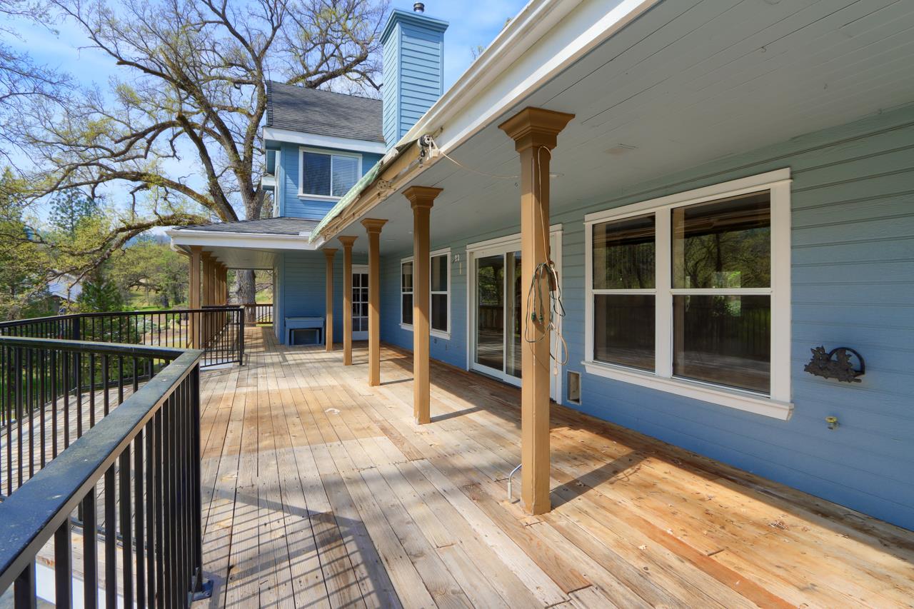 46580 Vista Del Rio Drive Oakhurst, CA 93644 - Photo 52 of 82 a view of a house with a large window and wooden fence