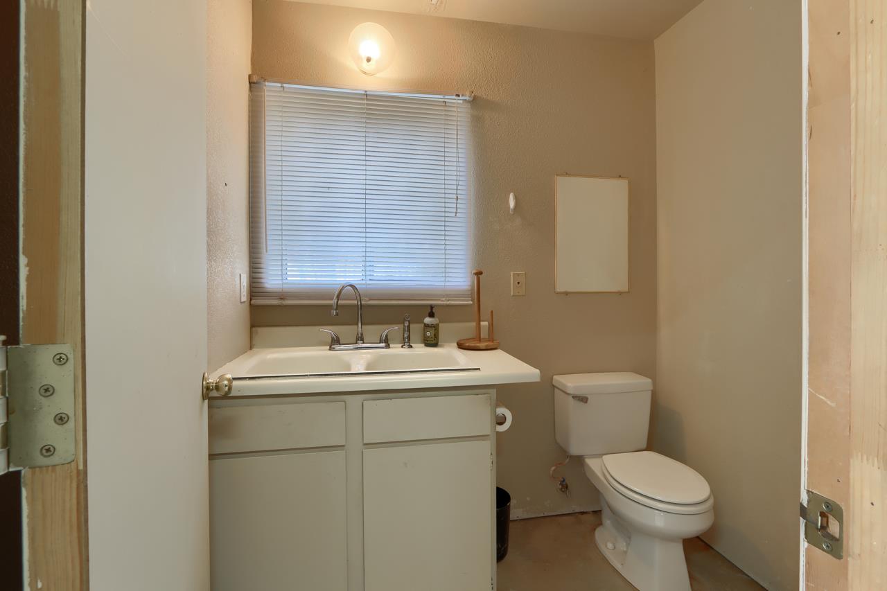 46580 Vista Del Rio Drive Oakhurst, CA 93644 - Photo 62 of 82 a bathroom with a toilet sink and mirror