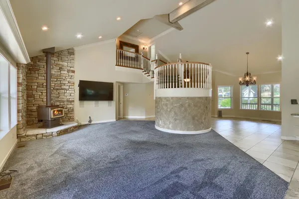 a kitchen with stainless steel appliances kitchen island granite countertop a refrigerator and microwave