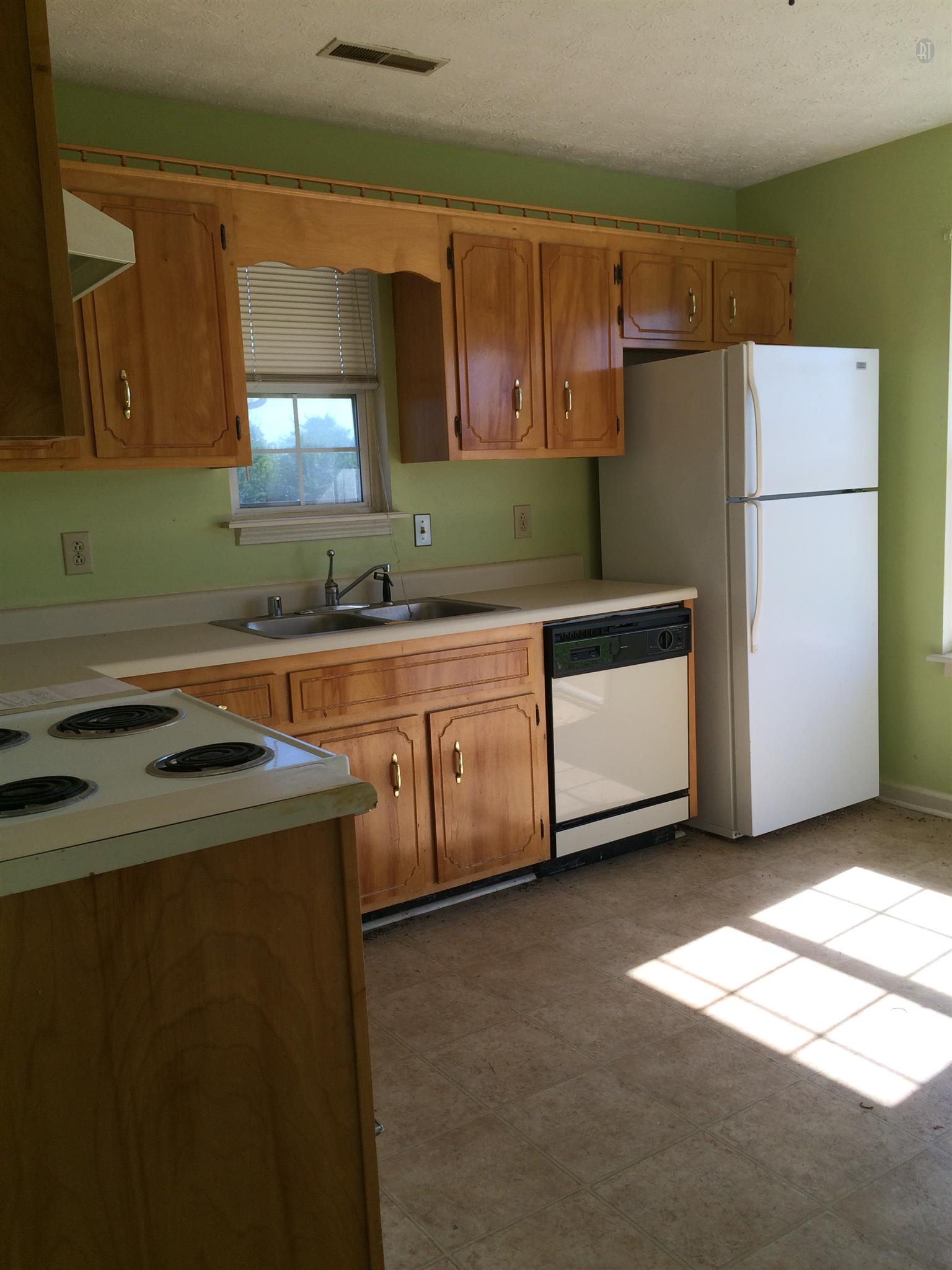 955 State Line Road Oak Grove, KY 42262 - Photo 7 of 14 a kitchen with a sink a stove and a refrigerator