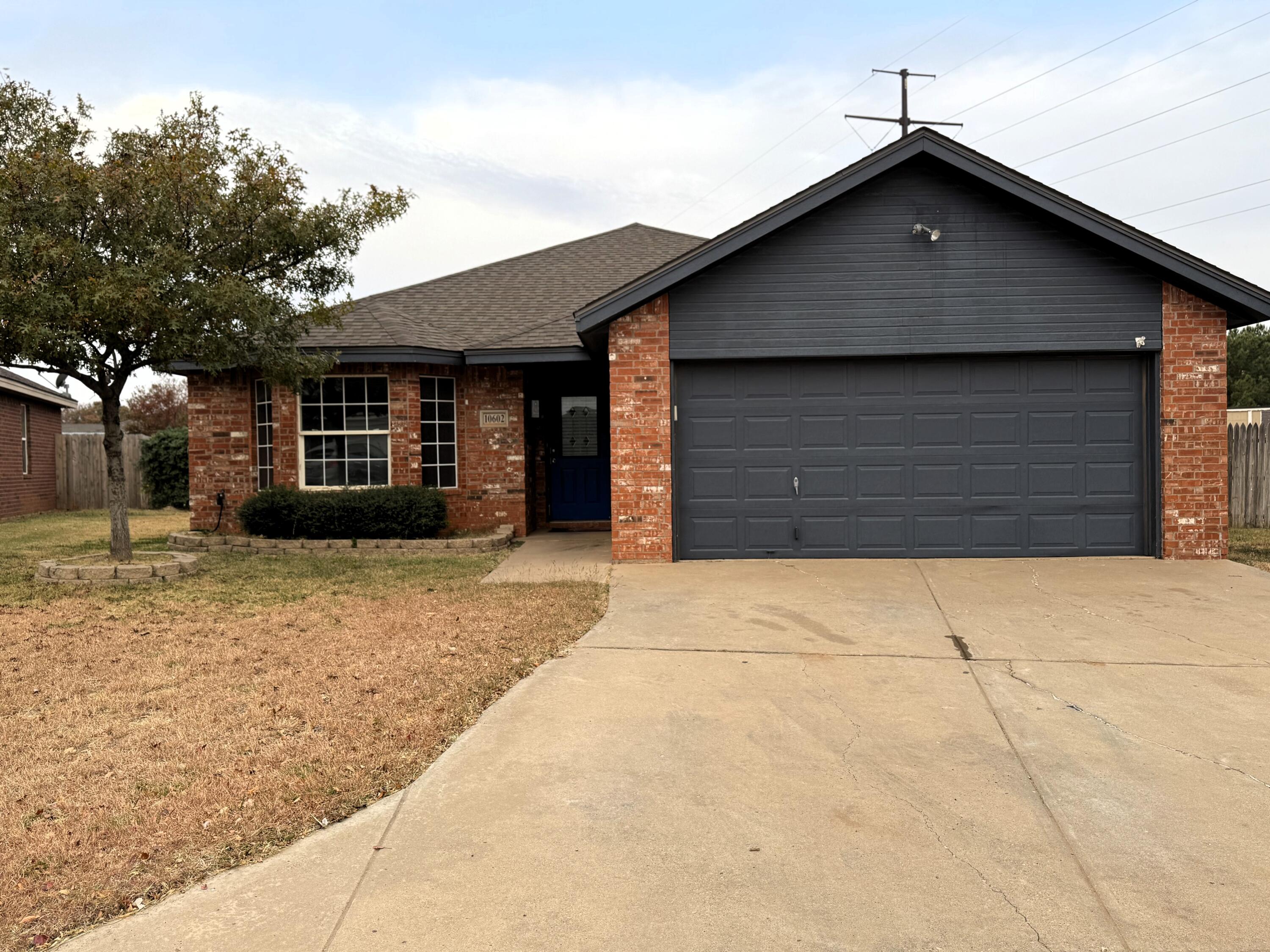 10602 Akron Avenue Lubbock, TX 79423 - Photo 1 of 16 a front view of a house with a garage