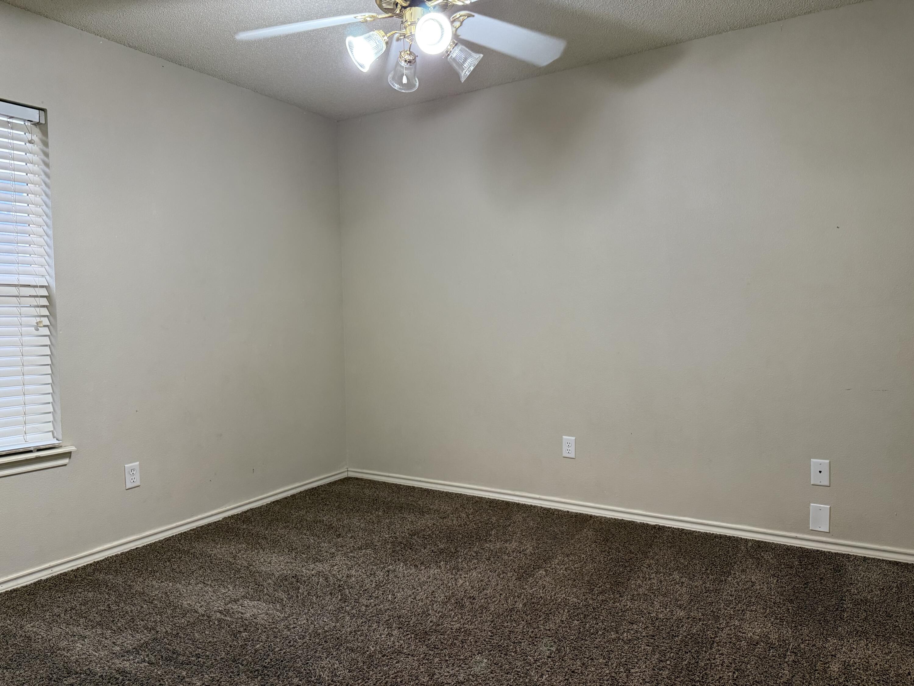 10602 Akron Avenue Lubbock, TX 79423 - Photo 12 of 16 an empty room with a empty space and a window