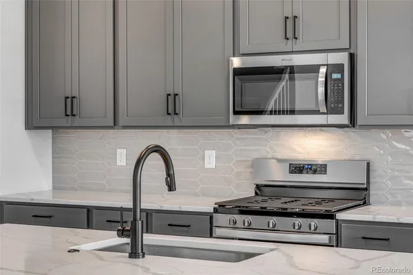 a stove top oven sitting inside of a kitchen
