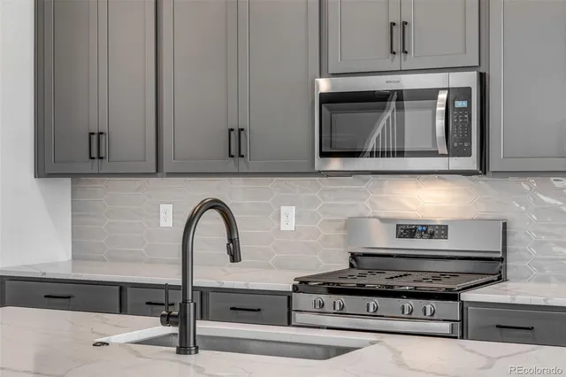 a stove top oven sitting inside of a kitchen