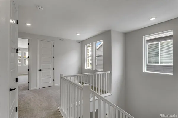 a view of an entryway with wooden floor and windows