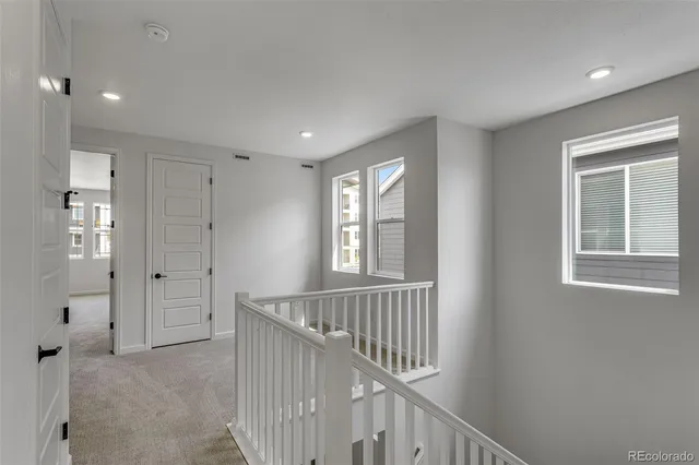 a view of an entryway with wooden floor and windows